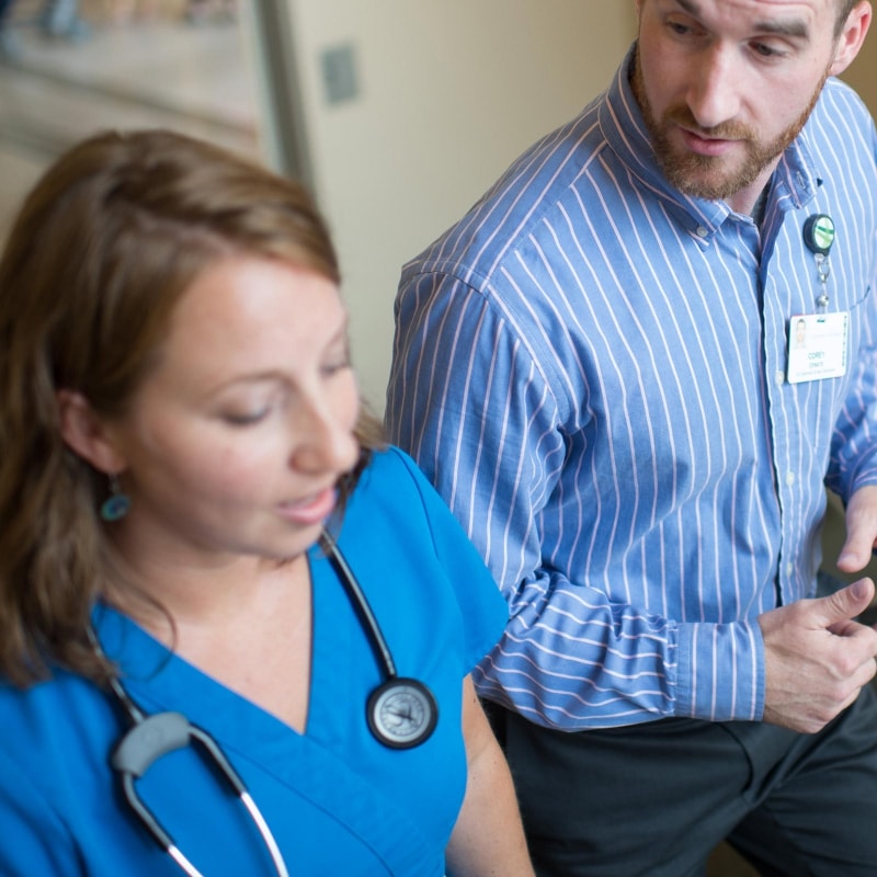 nurse and staff member talking