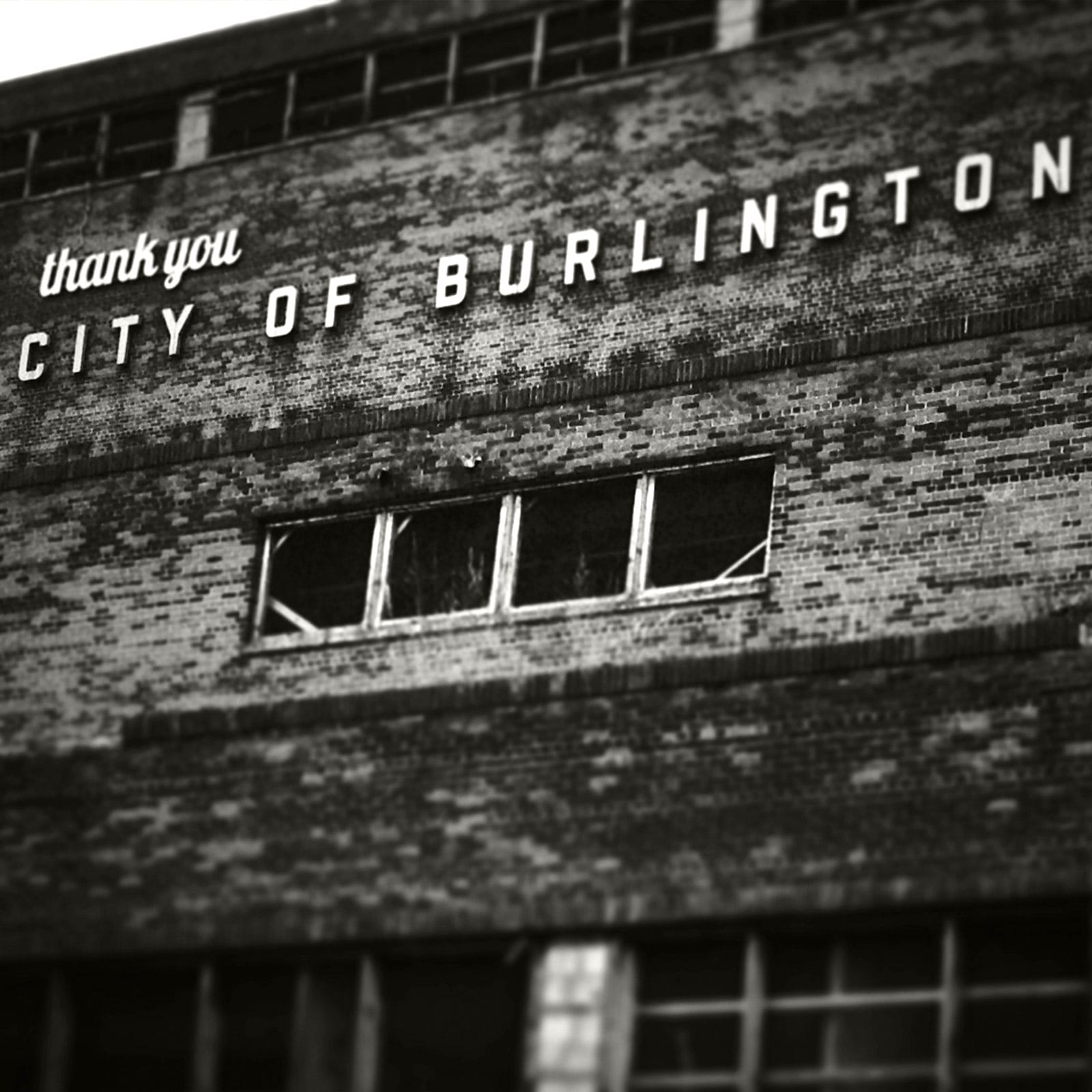 A brick wall with a sign that says Thank You City of Burlington